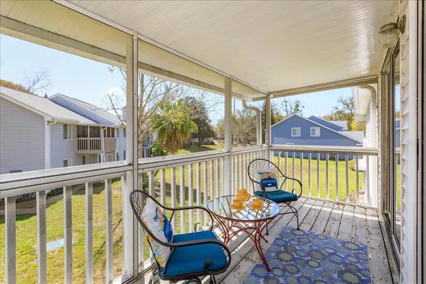 a view of a chair and tables in the balcony