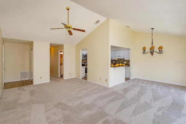 a view of a kitchen with a sink and refrigerator
