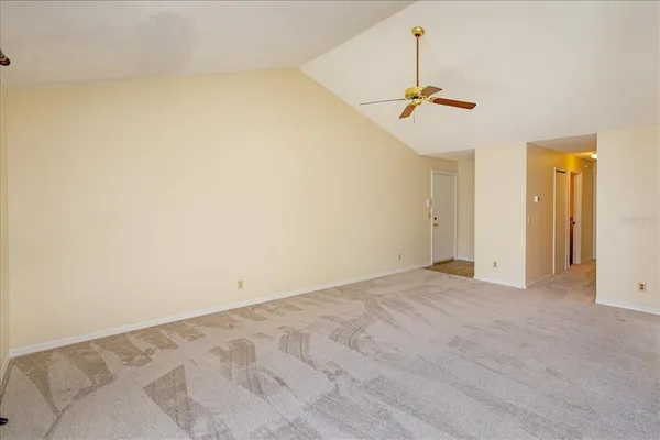 a view of empty room with ceiling fan
