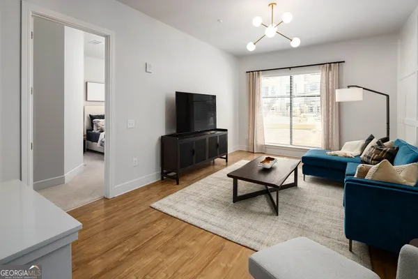 a living room with furniture and a flat screen tv