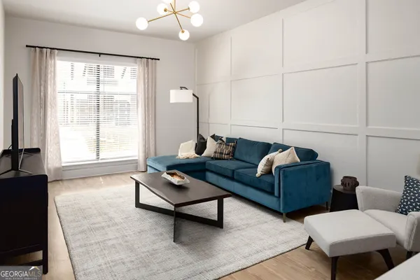 a living room with furniture and a large window