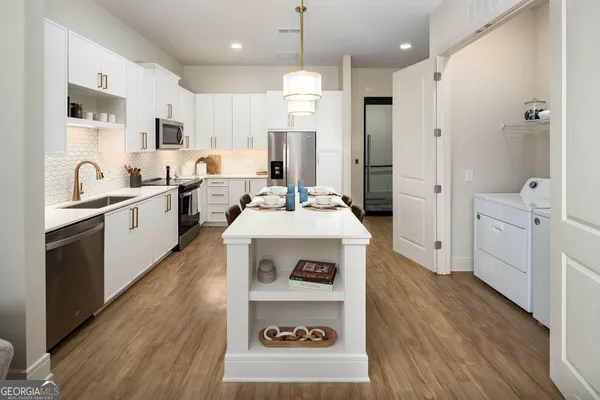 a kitchen with a sink stove and refrigerator
