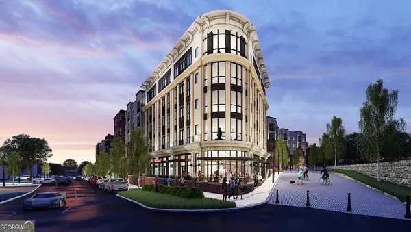 a view of a tall building next to a road