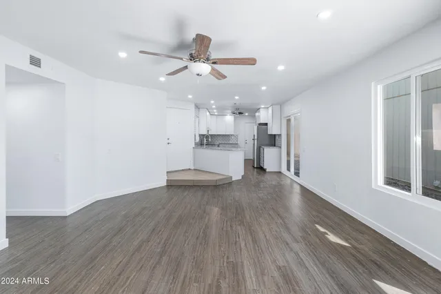 a view of a kitchen with a sink a refrigerator and window