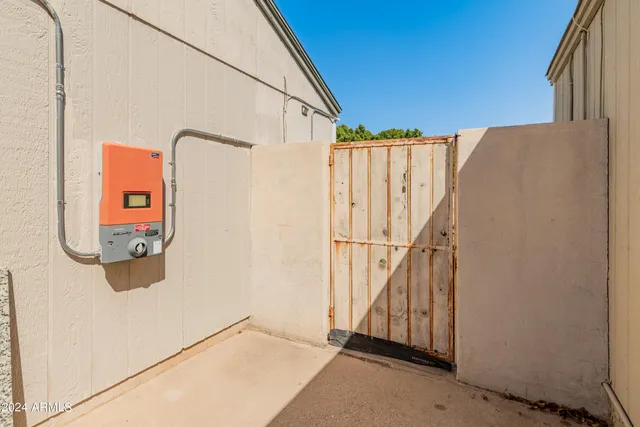 a view of a house with a wooden bench