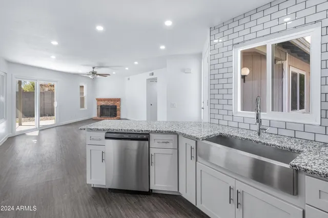 a kitchen with a sink stove and cabinets