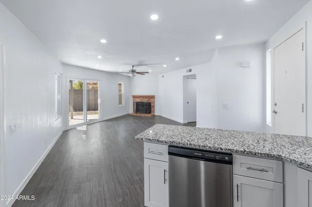 a view of kitchen with granite countertop cabinets and wooden floor