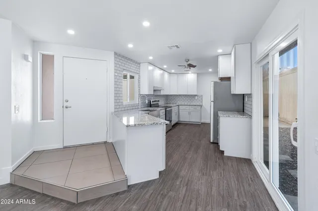 a view of kitchen with center island and stainless steel appliances