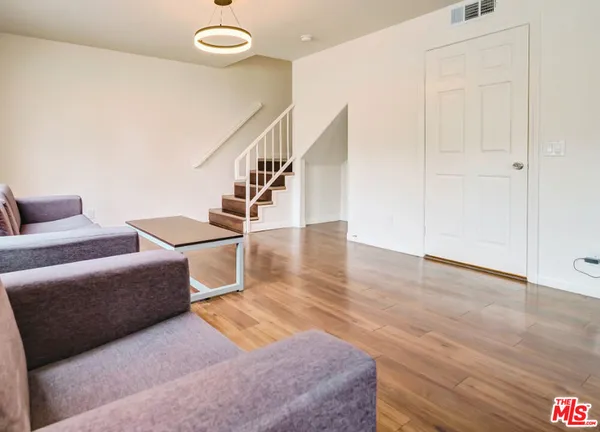 a living room with furniture and a stair