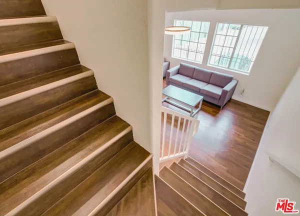 a view of staircase with wooden floor