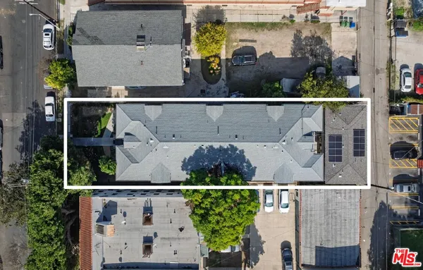 an aerial view of houses with a street