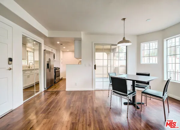 a view of a room with furniture and wooden floor