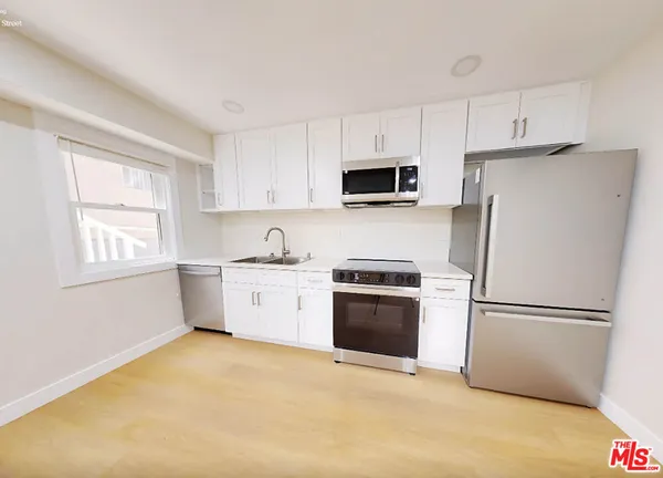a kitchen with a refrigerator stove and microwave