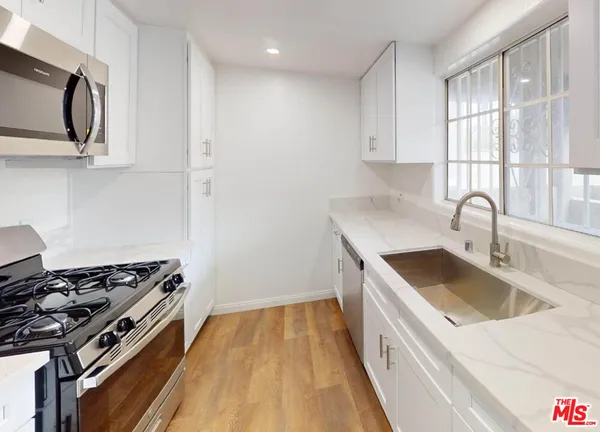 a kitchen that has a sink and a stove