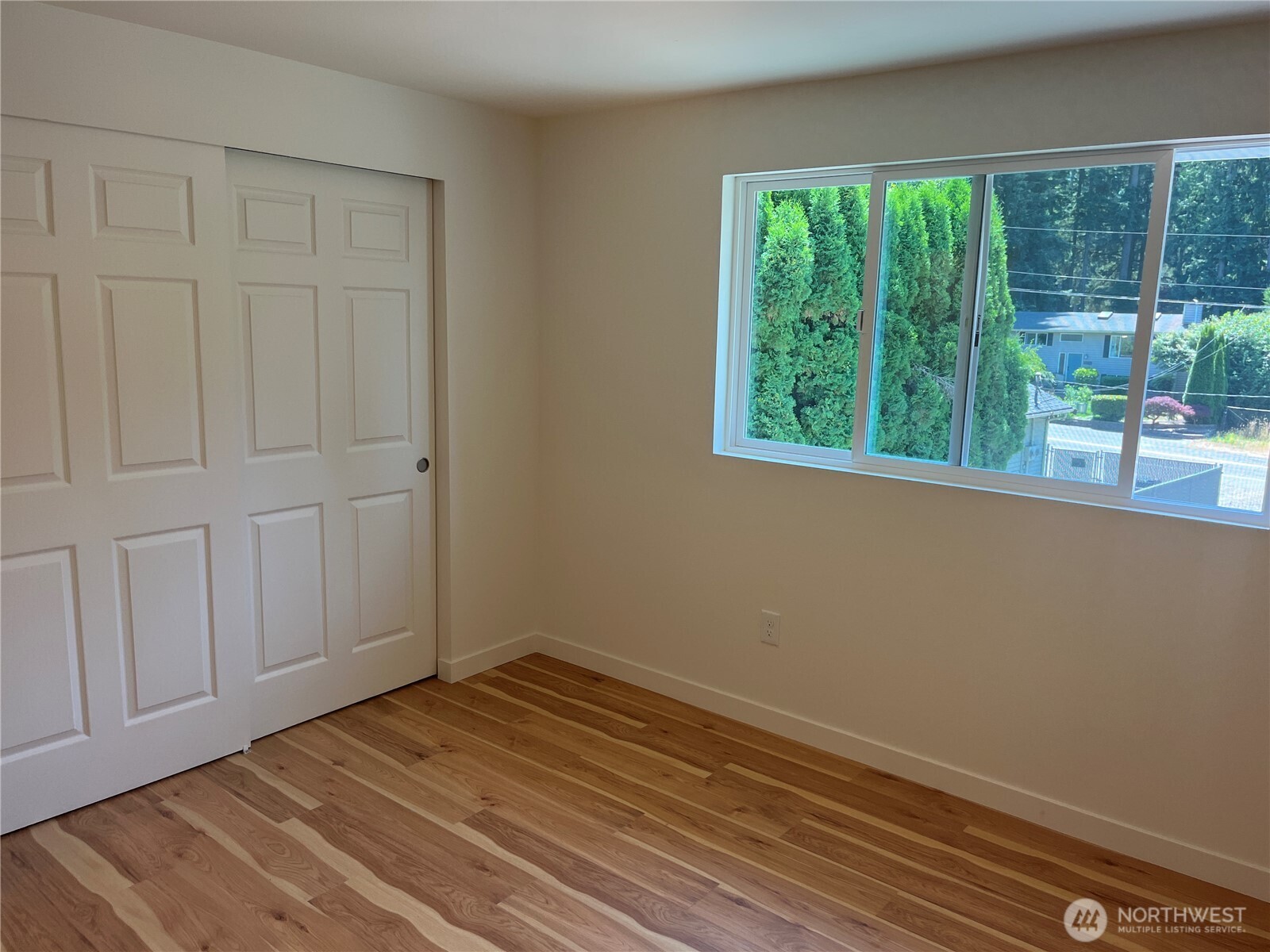 411 170th Place Southwest, Unit 2 Bothell, WA 98012 - Photo 13 of 15 an empty room with wooden floor and windows