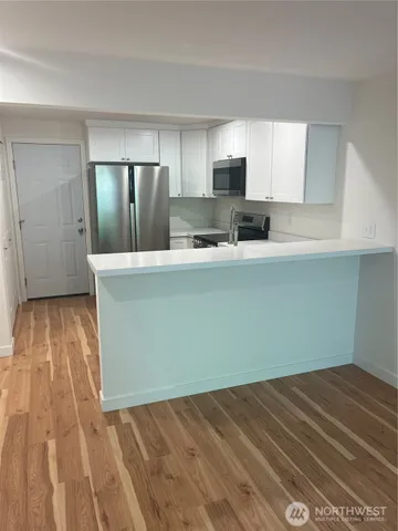 a view of kitchen with wooden floor