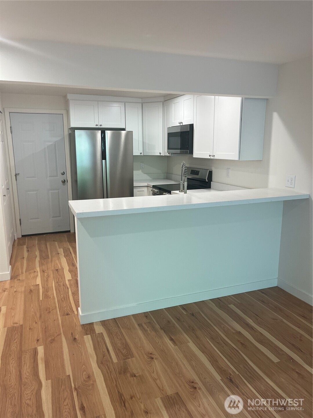 411 170th Place Southwest, Unit 2 Bothell, WA 98012 - Photo 3 of 15 a view of kitchen with wooden floor