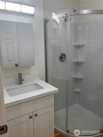a bathroom with a sink a mirror and shower