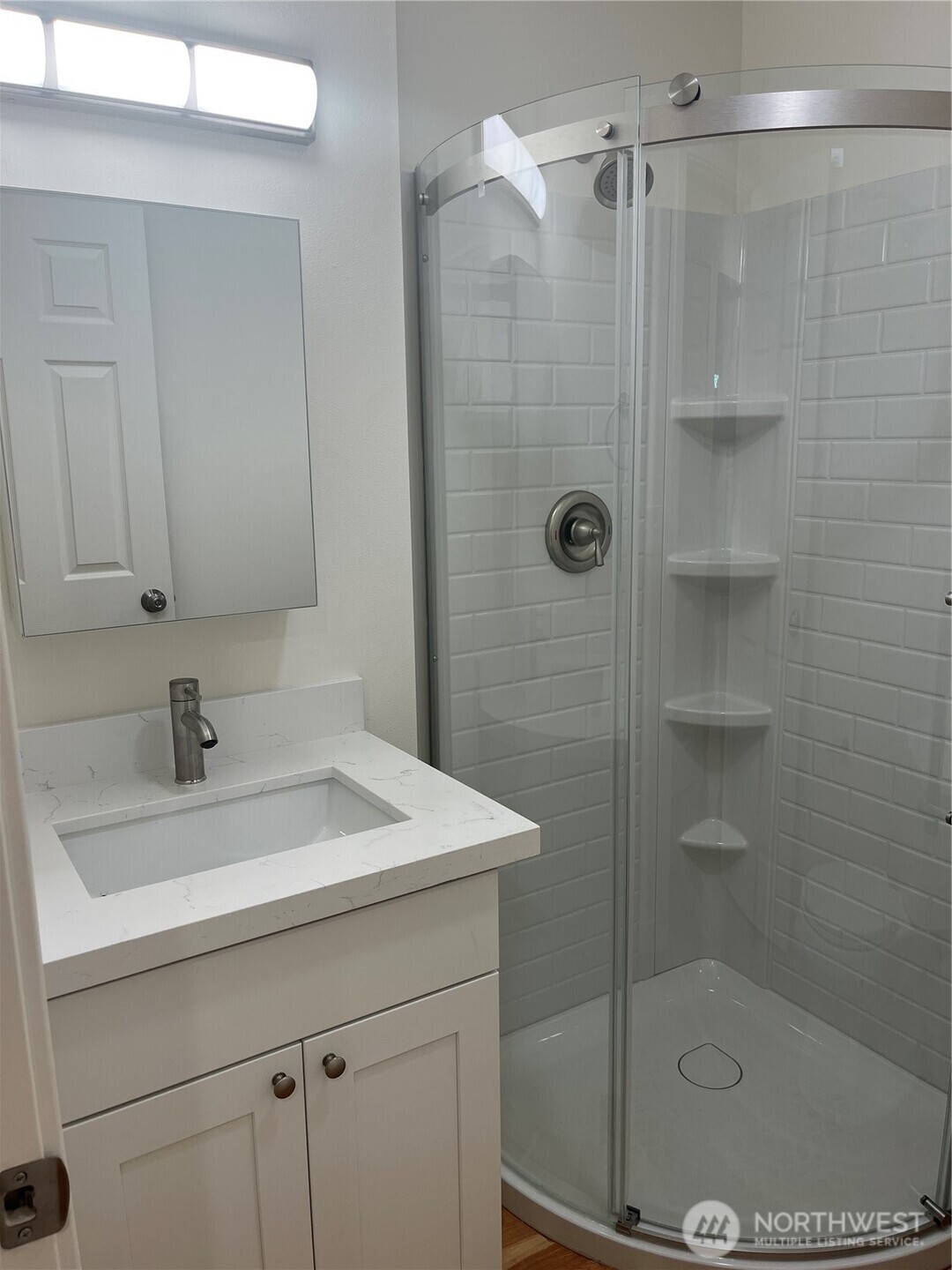 411 170th Place Southwest, Unit 2 Bothell, WA 98012 - Photo 5 of 15 a bathroom with a sink a mirror and shower