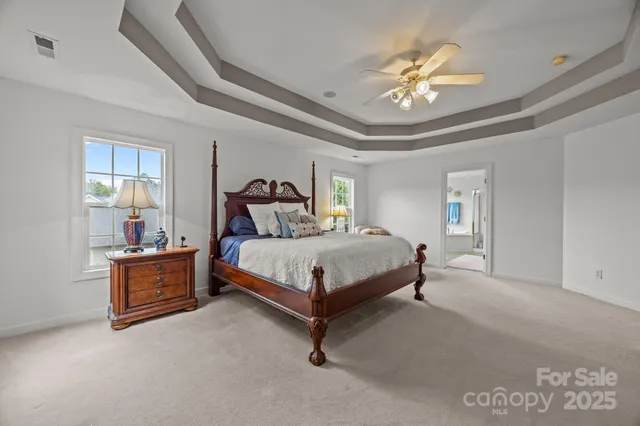 a bedroom with a bed and a chandelier
