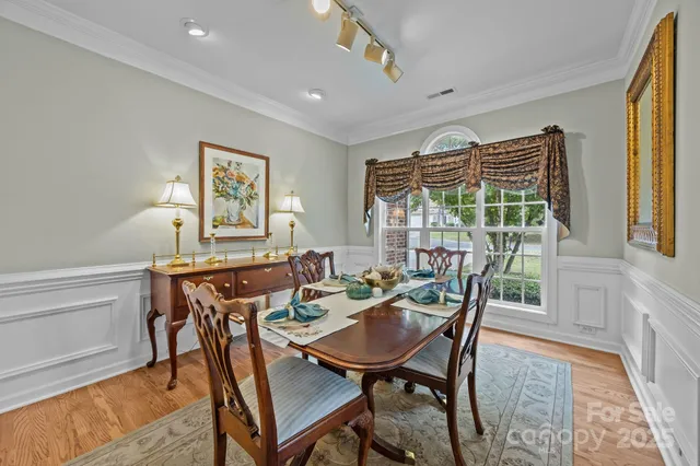 a view of a dining room with furniture and a window