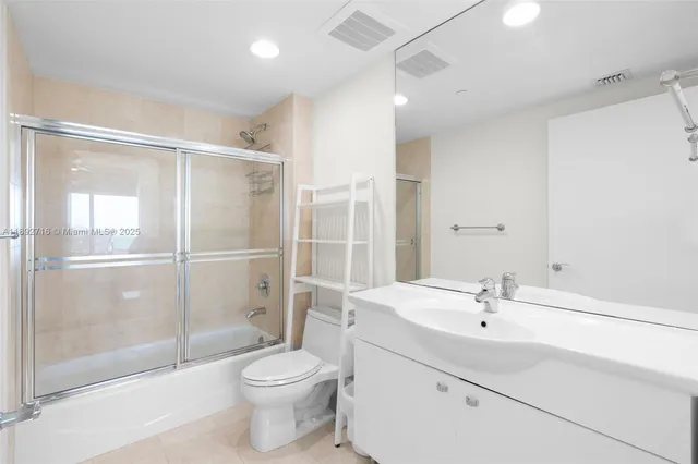 a bathroom with a toilet sink and a shower