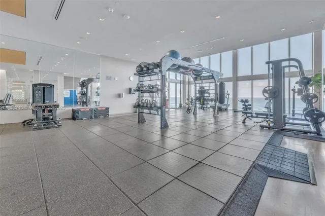 a living room with lots of furniture and a chandelier