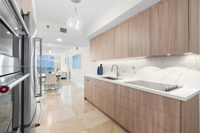 a kitchen with stainless steel appliances kitchen island granite countertop a sink and cabinets