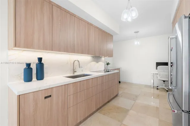 a kitchen with a sink cabinets and window