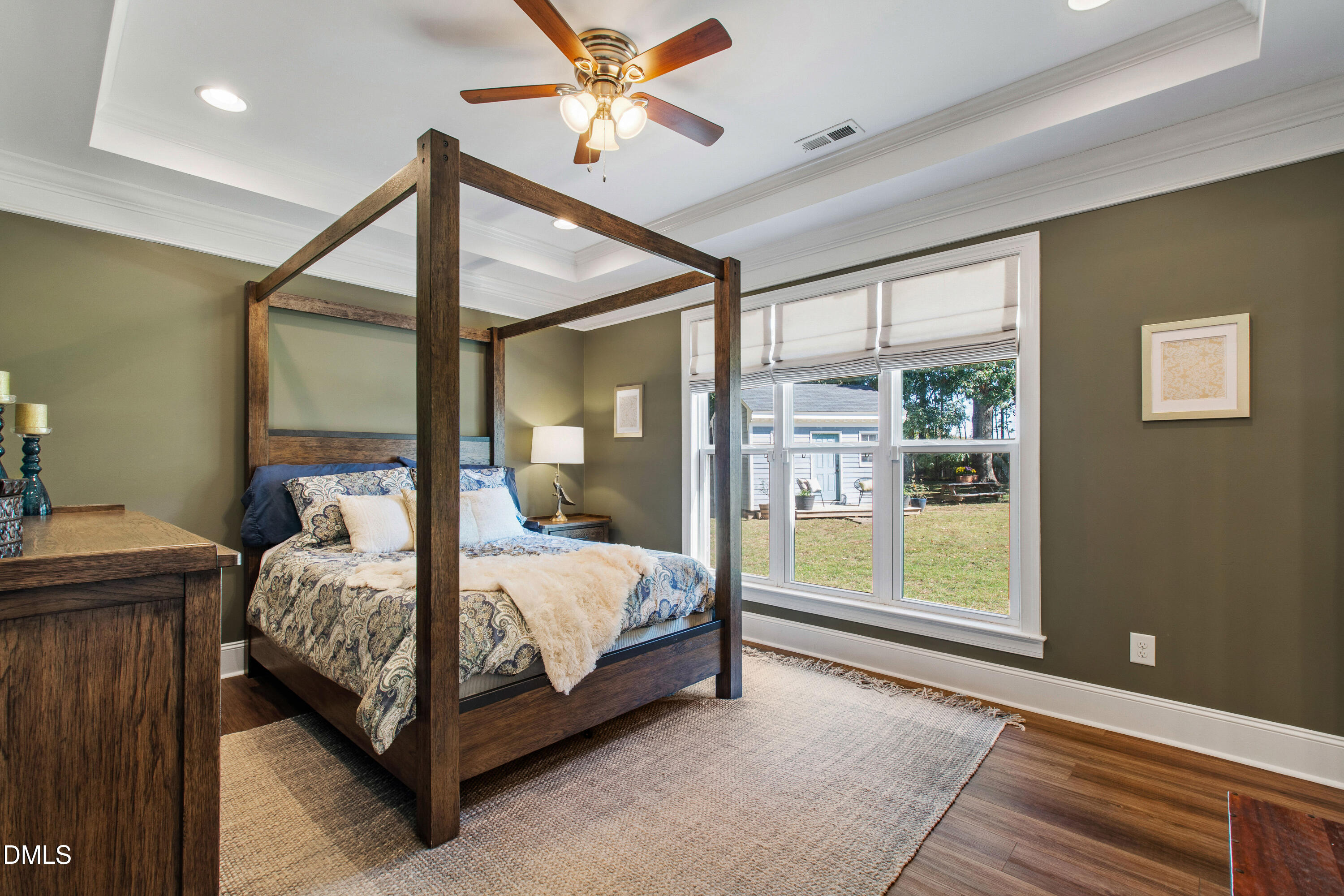 5505 Spring Road Raleigh, NC 27603 - Photo 23 of 41 a bedroom with a large bed and a chandelier