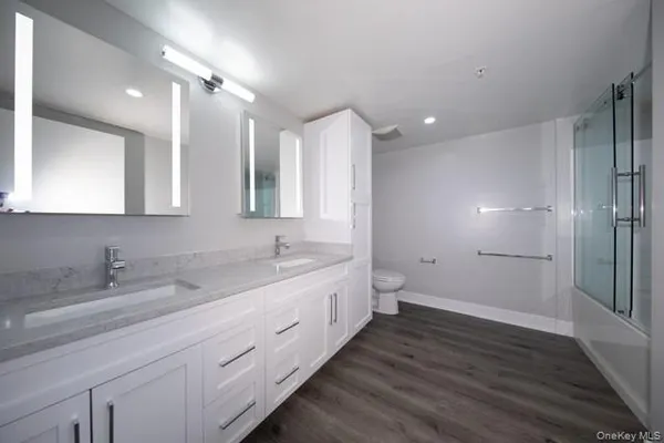 a bathroom with a double vanity sink and mirror