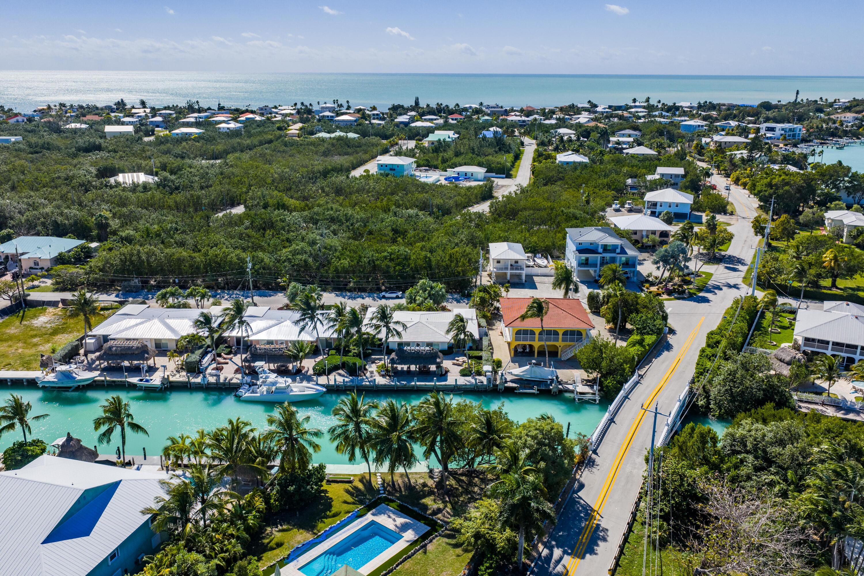 116 Indies Drive North Marathon, FL 33050 - Photo 23 of 67 an aerial view of residential houses with outdoor space and lake view in back