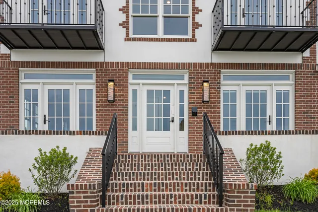 a view of a house with a small deck