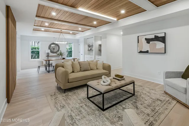 a living room with furniture and a clock