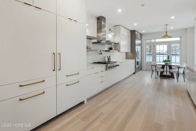a large white kitchen with cabinets