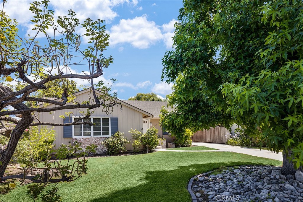 a front view of a house with a garden