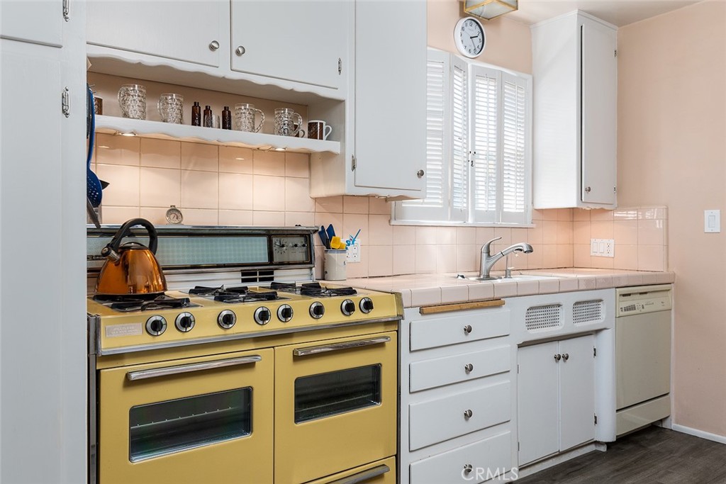 3280 Orlando Road Pasadena, CA 91107 - Photo 12 of 26 a kitchen with stainless steel appliances granite countertop a stove and a white cabinets