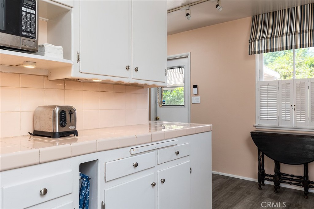 3280 Orlando Road Pasadena, CA 91107 - Photo 13 of 26 a kitchen with granite countertop white cabinets and a window