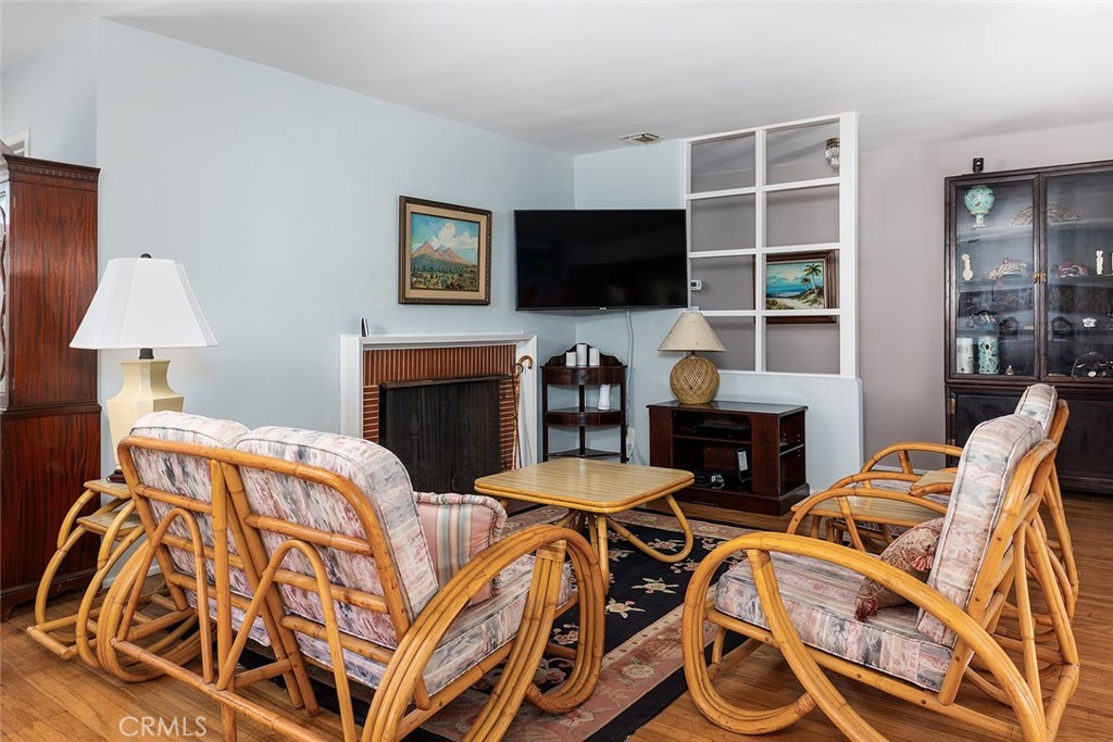 3280 Orlando Road Pasadena, CA 91107 - Photo 6 of 26 a living room with furniture a flat screen tv and a fireplace