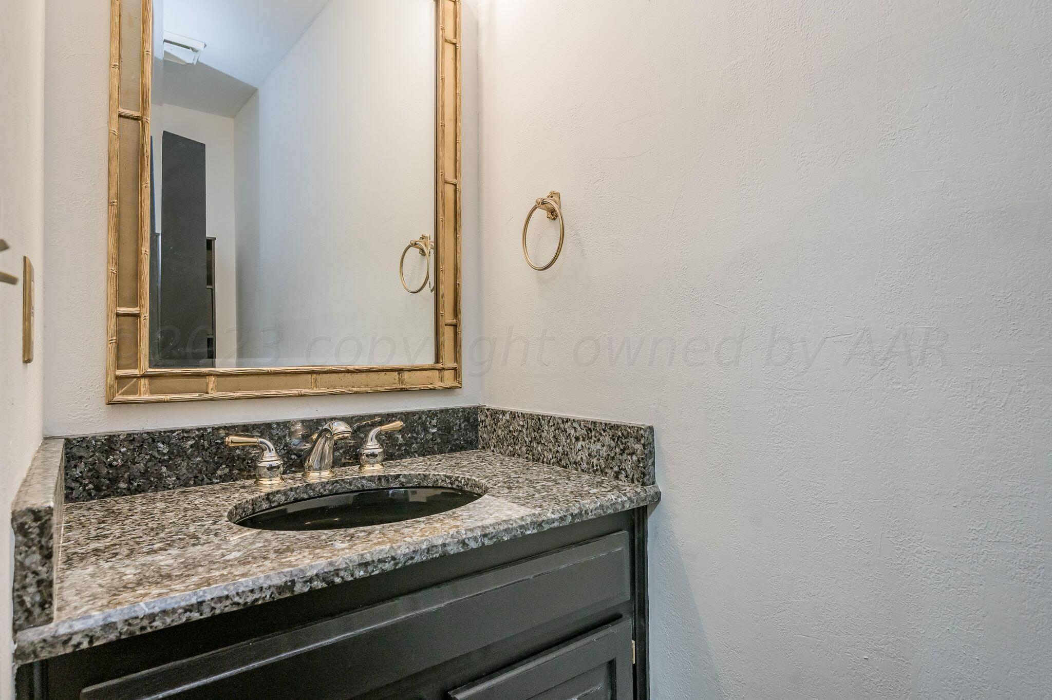 1109 Bennett Drive Dumas, TX 79029 - Photo 20 of 21 a bathroom with a granite countertop sink and a mirror