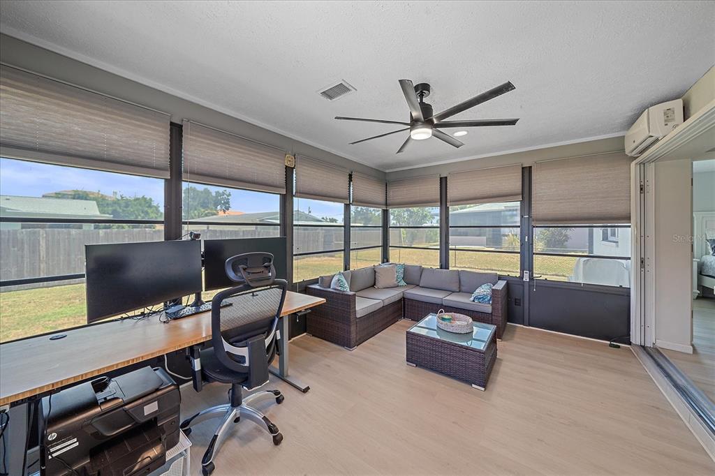 1488 Jupiter Road Venice, FL 34293 - Photo 16 of 21 a living room with furniture a ceiling fan and a large window