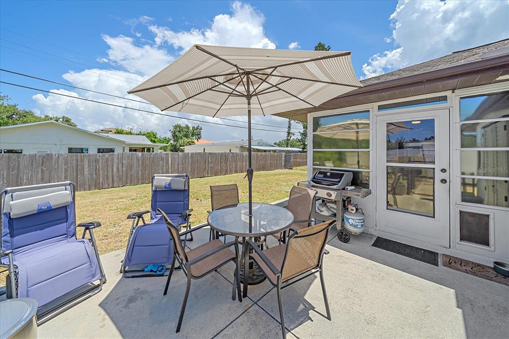 1488 Jupiter Road Venice, FL 34293 - Photo 17 of 21 a view of a backyard with a dining table and chairs