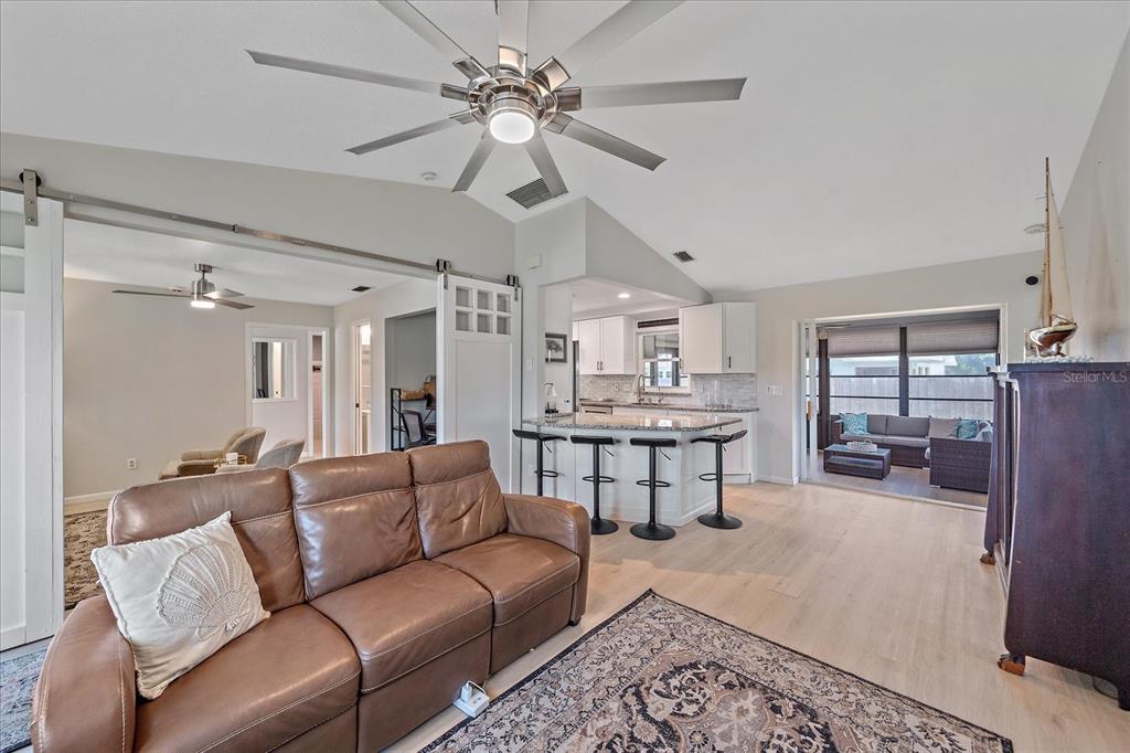 1488 Jupiter Road Venice, FL 34293 - Photo 8 of 21 a living room with furniture a chandelier and a piano