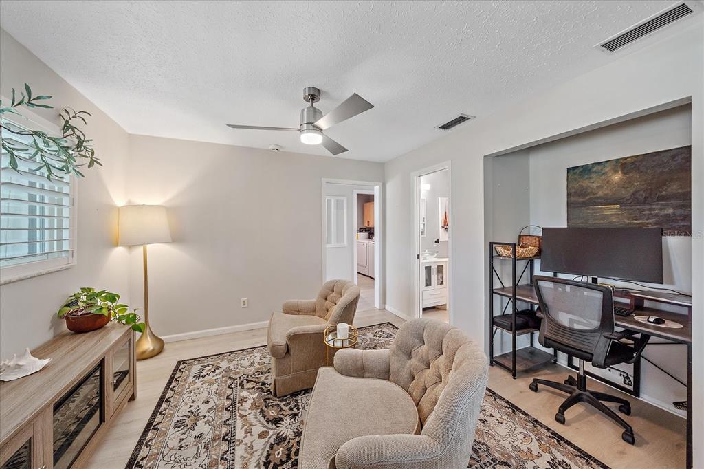 1488 Jupiter Road Venice, FL 34293 - Photo 9 of 21 a living room with furniture a lamp and a chandelier