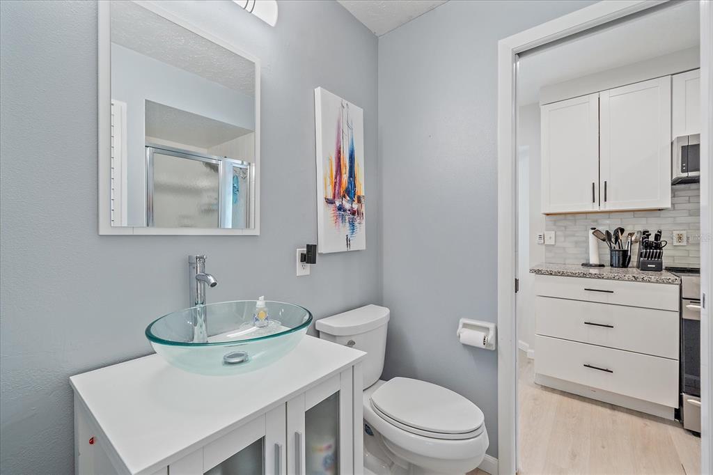 1488 Jupiter Road Venice, FL 34293 - Photo 10 of 21 a bathroom with a sink toilet and mirror