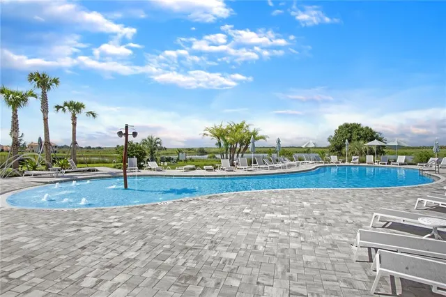 a view of a house with swimming pool and sitting area