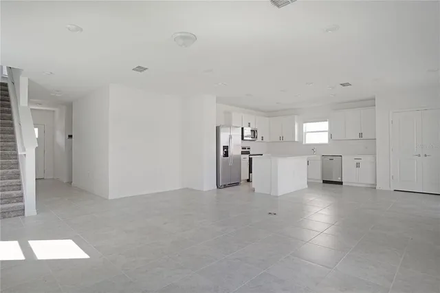 a view of a livingroom with kitchen and furniture