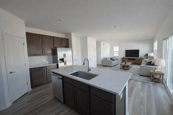 a kitchen with a sink stove and refrigerator