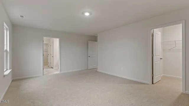 a view of an empty room and a window