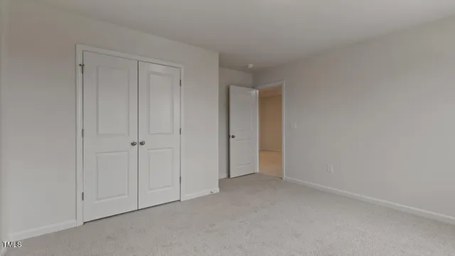 a view of an empty room and closet area